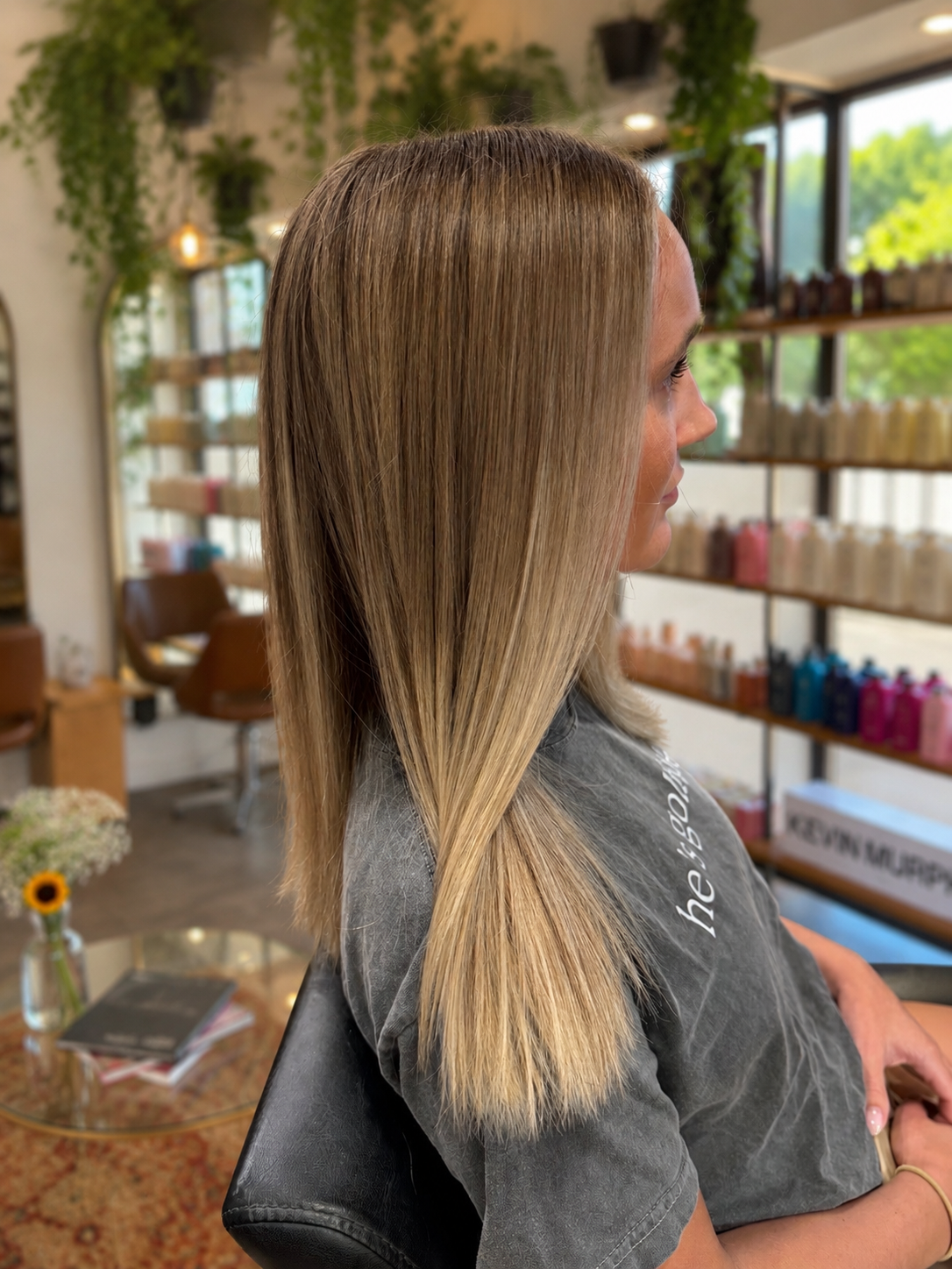 Sleek blonde haircut and soft face framing color at Salon NB