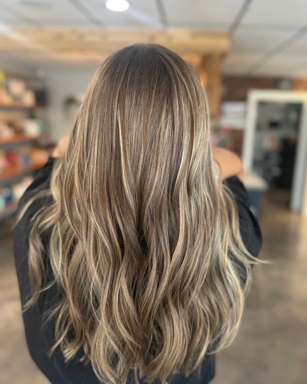 Salon NB long blonde highlights styled in soft waves