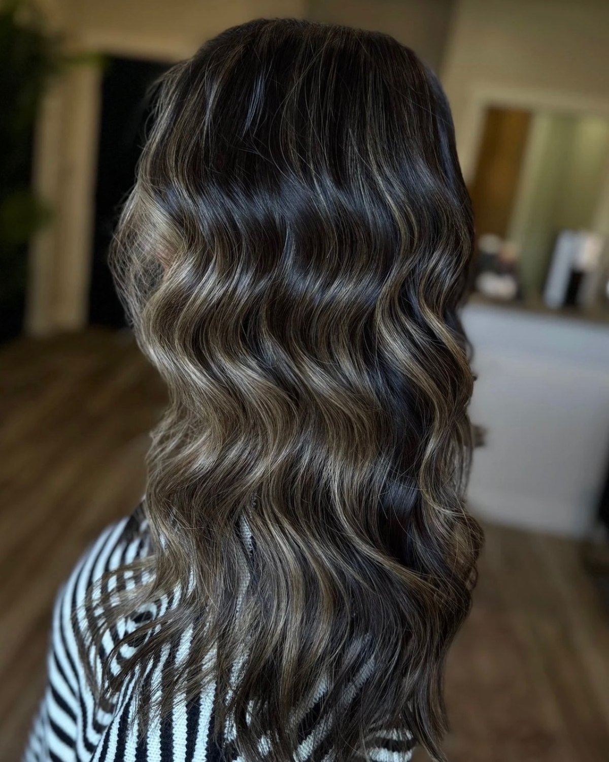 Salon NB glossy brunette waves styled from the back