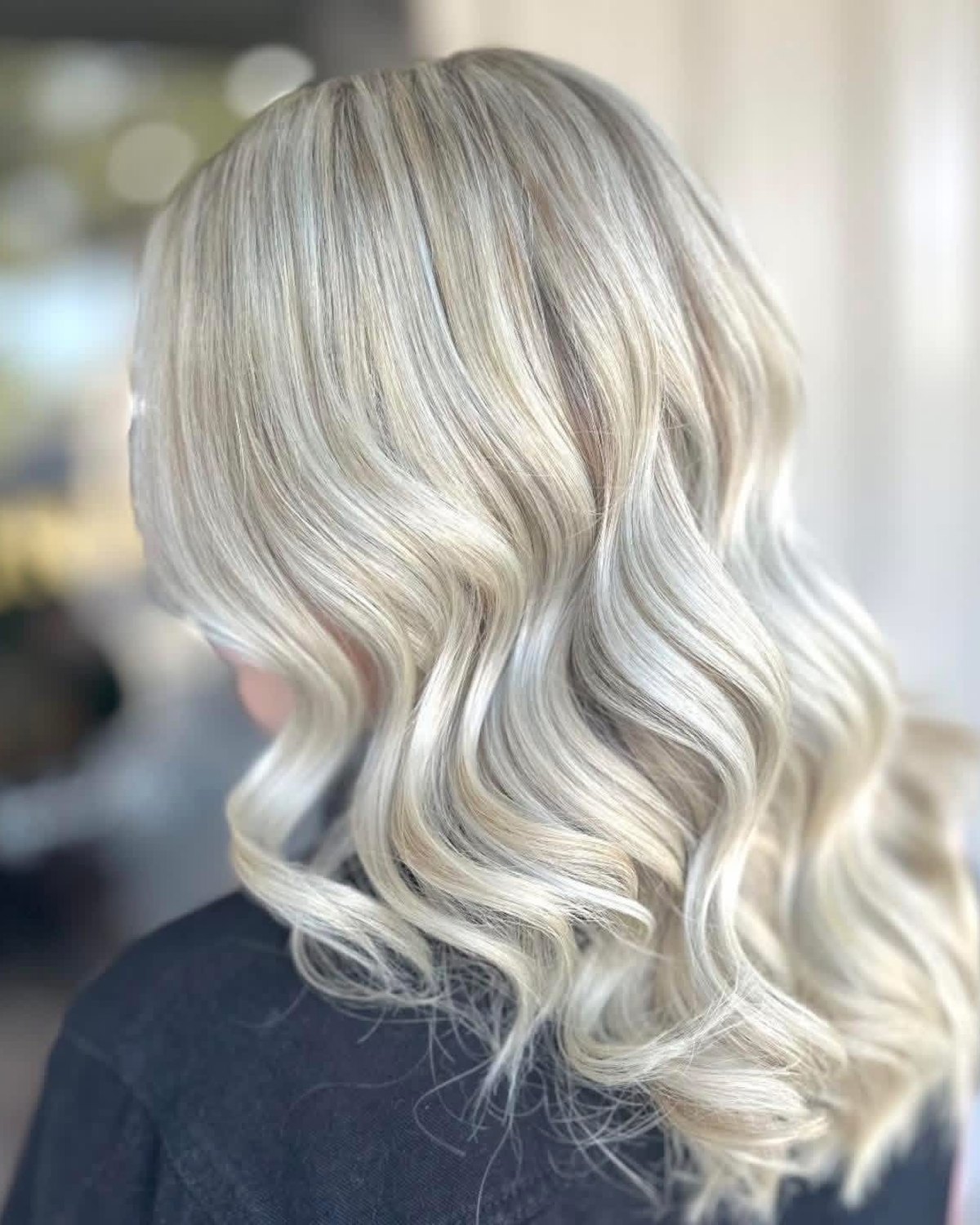 Salon NB icy blonde curls with bright dimensional highlights