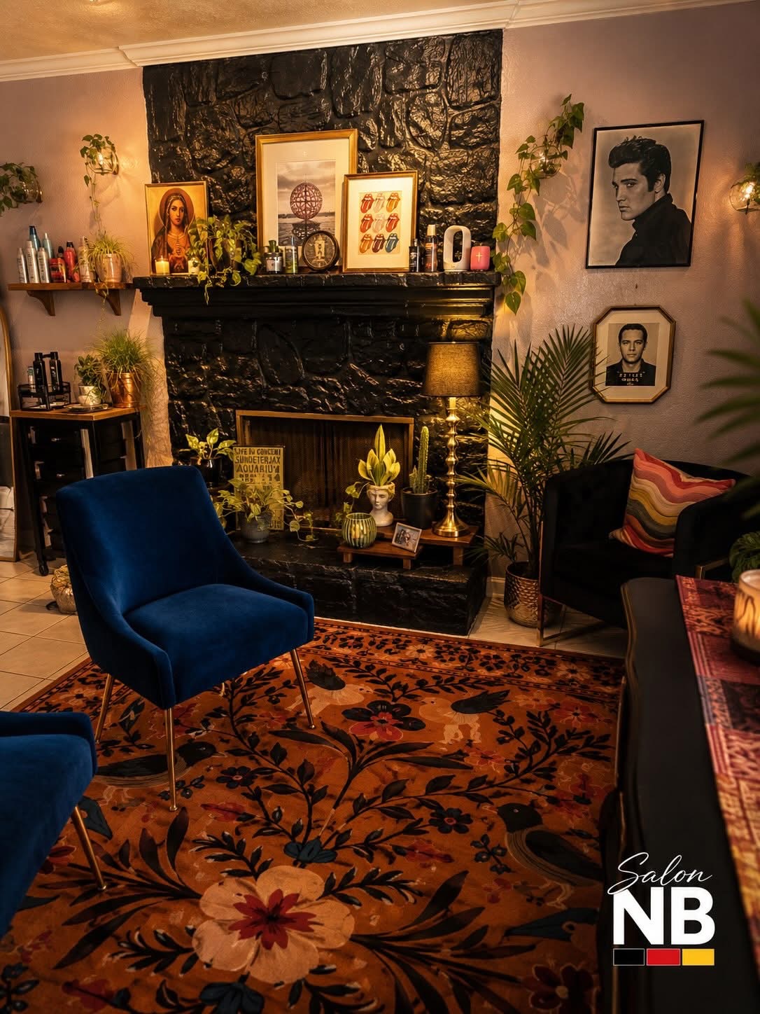 Warm Salon NB lounge with art, plants, black fireplace, and blue velvet chair