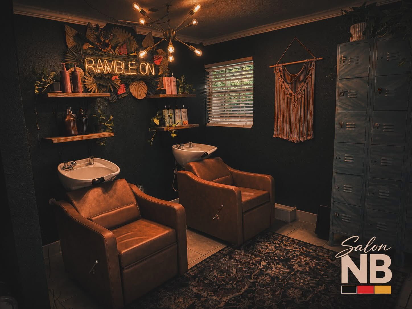 Salon NB shampoo room with leather shampoo chairs, dark walls, and warm lights